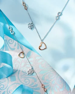 Bransoletka z białego i różowego złota z diamentami - serce, nieskończoność, koniczyna - 0,01 ct - próba 375