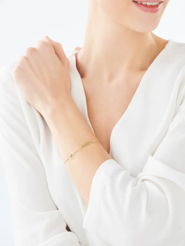 Bransoletka z żółtego i białego złota z brylantem - piórko - 0,005 ct - próba 375