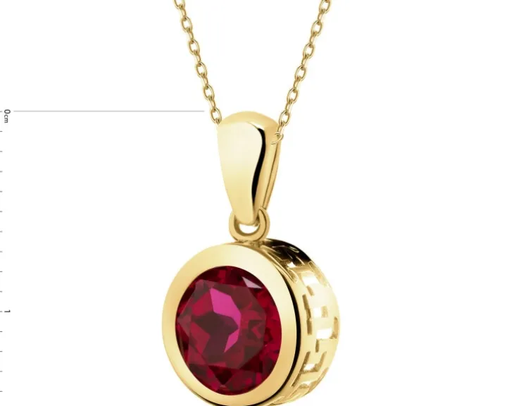 Złota zawieszka z korundem syntetycznym