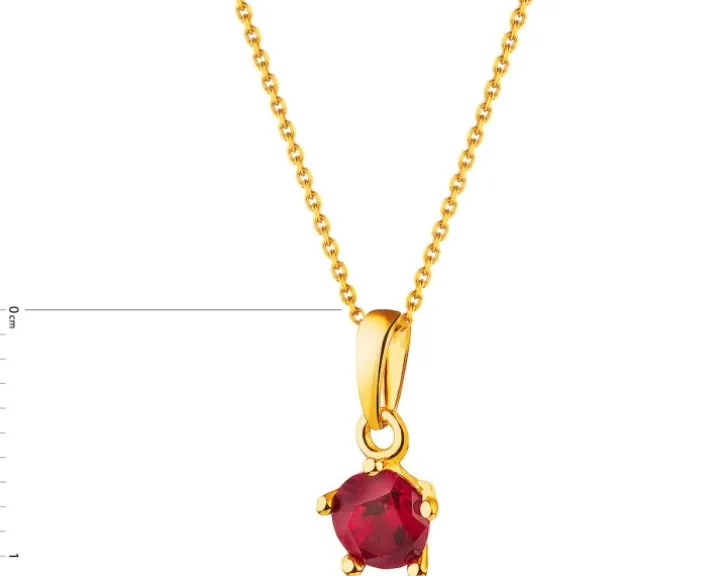Złota zawieszka z rubinem syntetycznym